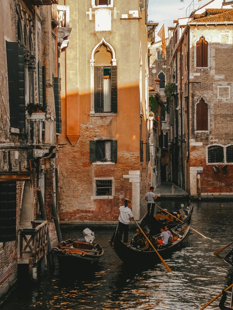 A gondola on a side canal in Venice at golden hour